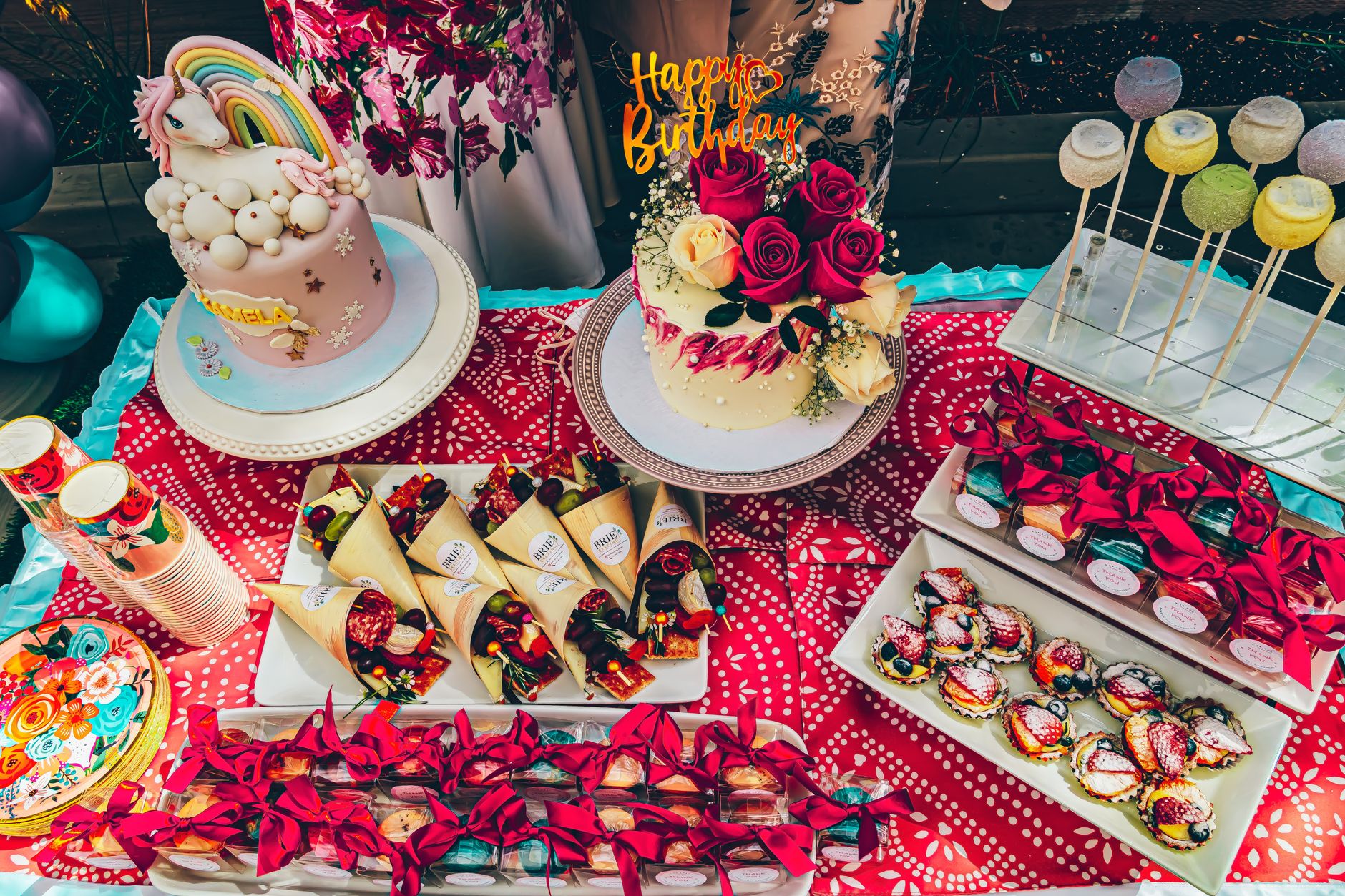 Table anniversaire arc-en-ciel avec gâteaux